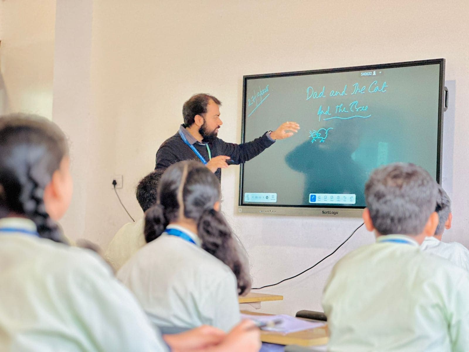 Teacher conducting interactive digital smart board lesson with students at Mount Litera Zee School Wagholi
