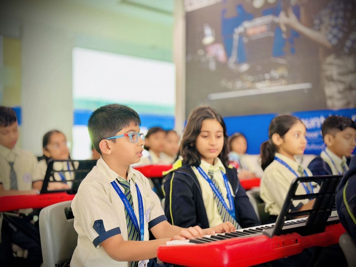 Students exploring creative digital arts and musical instruments in the media wing